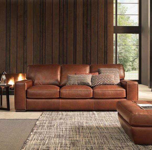 Warm, brown leather Natuzzi Editions sofa in a chocolate panelled room